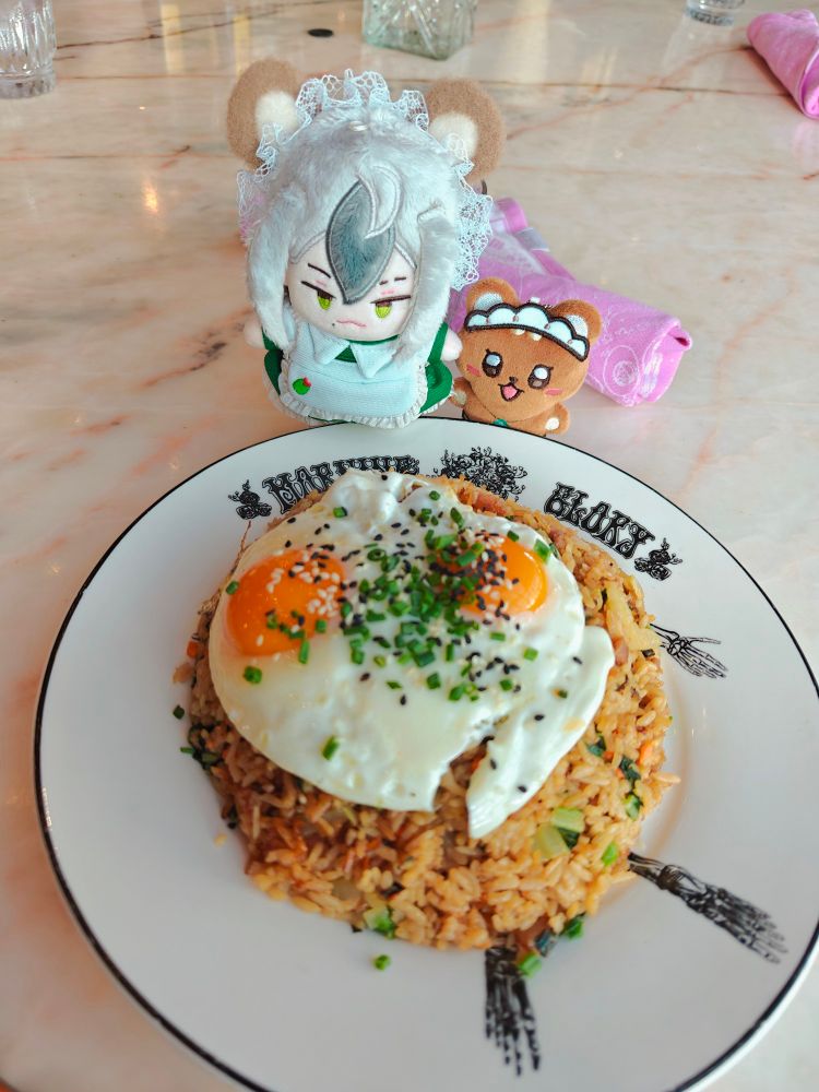 rei and eiden stare longingly at a plate of fried rice with over easy eggs on top