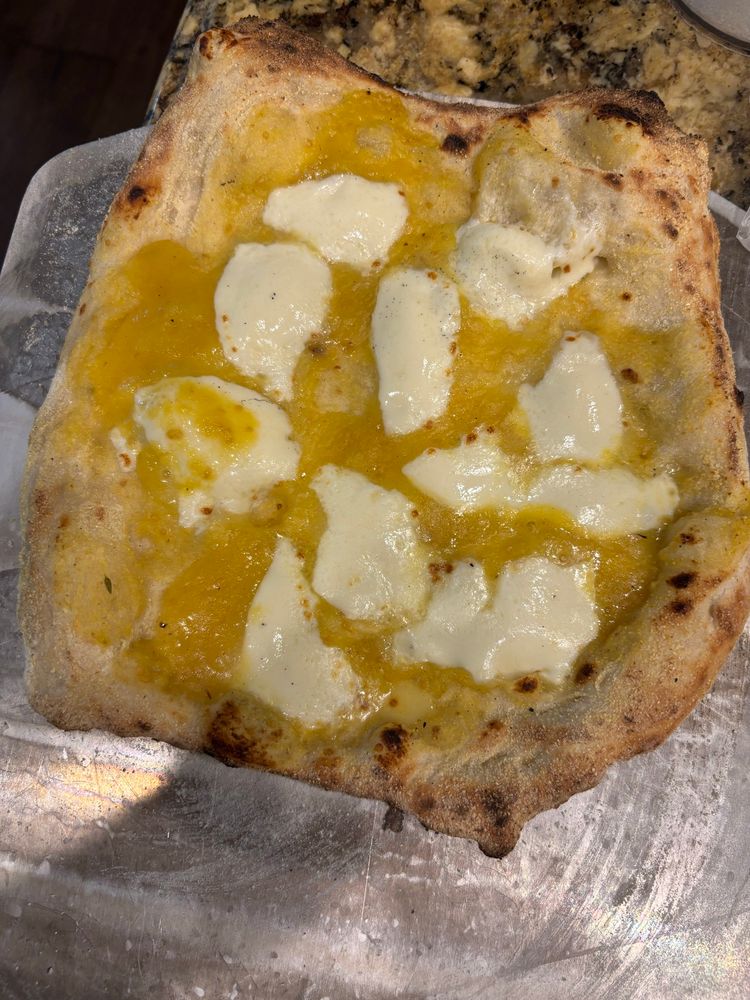 a neapolitan margherita pizza with yellow tomato sauce