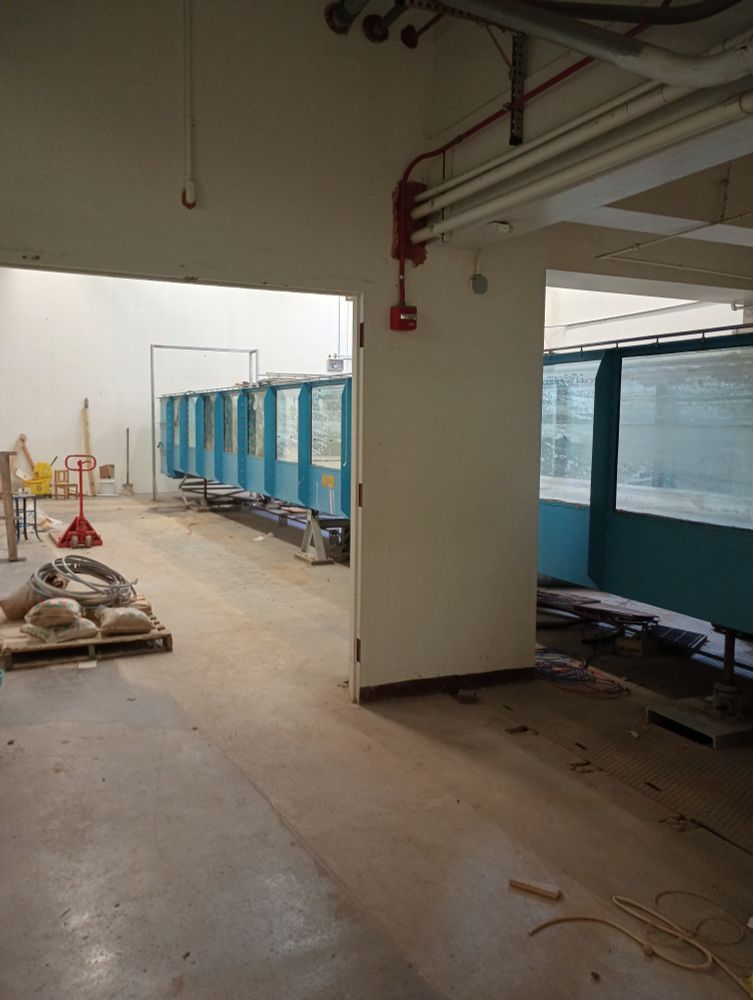 Image of an almost empty lab with a large hydraulics flume. 
