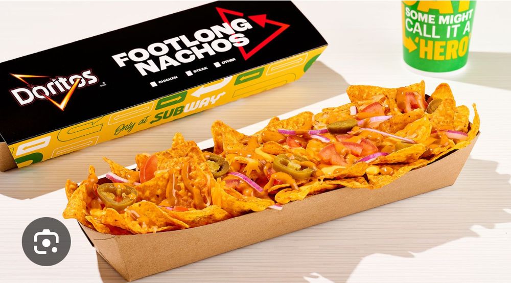 some crispy nachos arranged artfully in a cardboard tray, vibrantly colored and looking perky