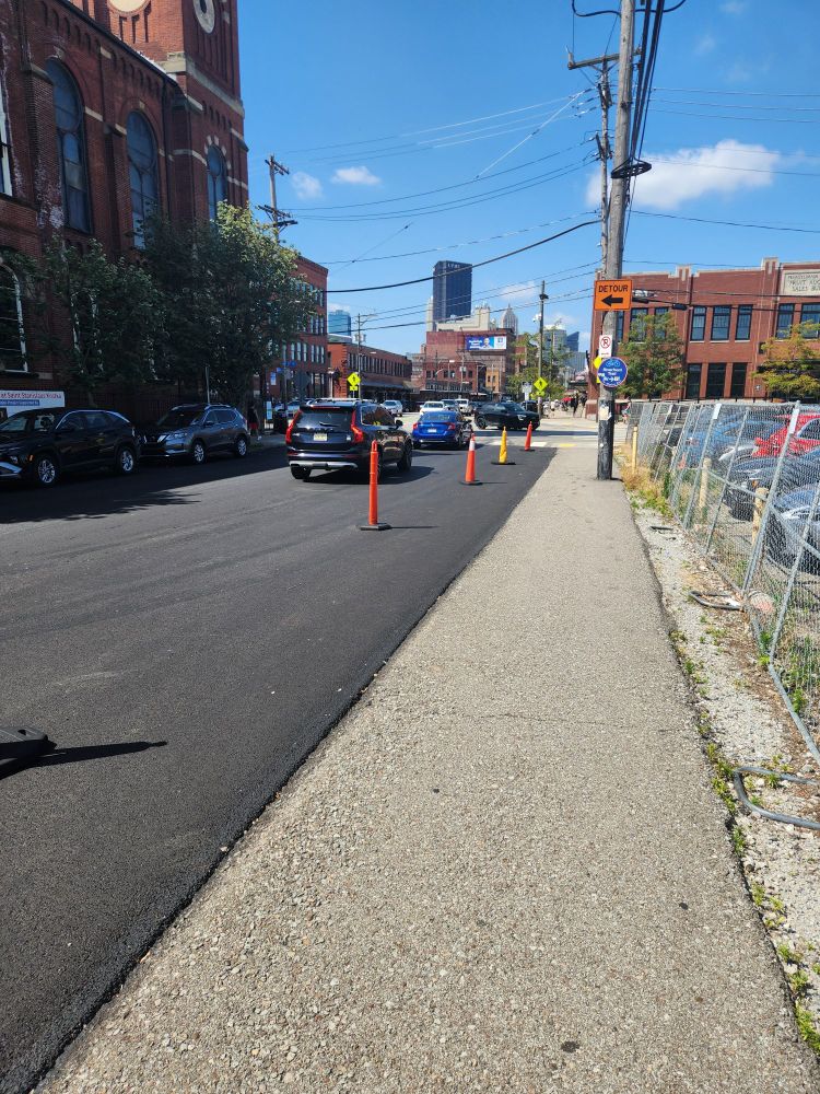 A picture of a section of the Strip District. You can see the US Steel tower, which is the most prominent building. Some cones exist.