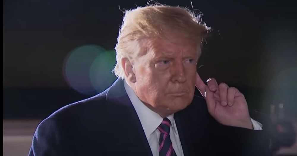 Trump holding his finger to his ear as he learns Ruth Bader Ginsberg has passed