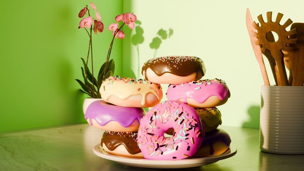 A plate of donuts placed on a marble counter top in front of an orchid(?) and beside a container full of wooden utensils.