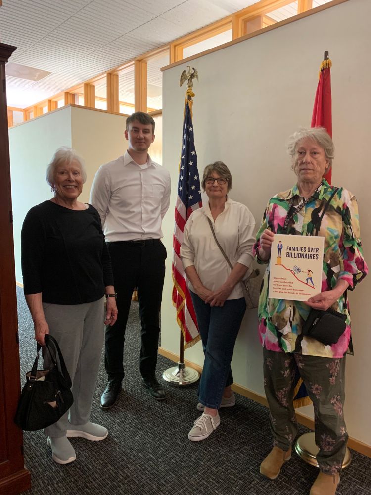 Three constituents and one staffer pose with the storybook.”