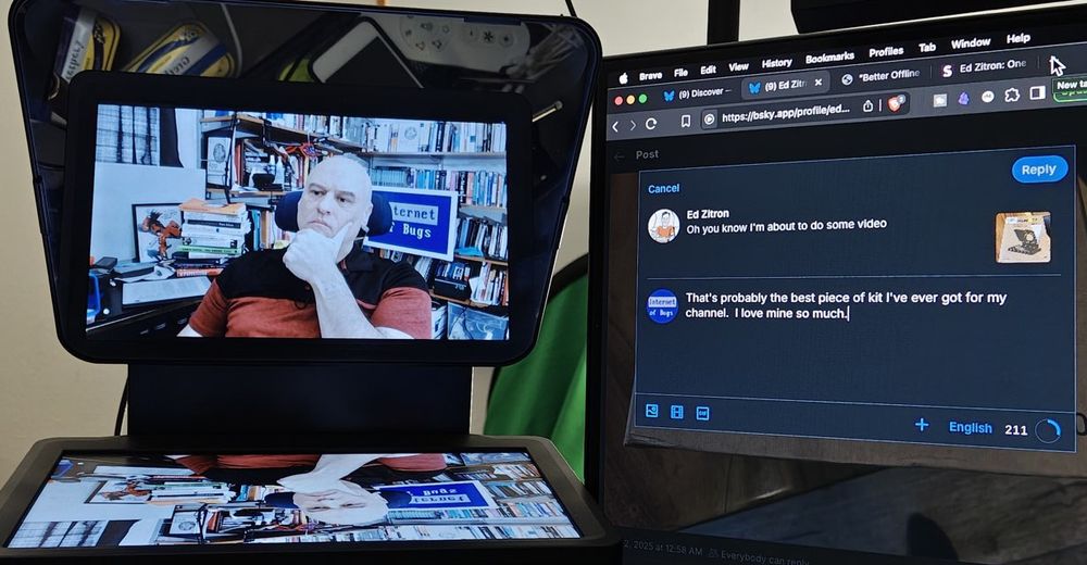 Picture of my Elgato Teleprompter next to my monitor. The teleprompter screen has a screenshot of a recent Zoom call, and the monitor next to it shows the text content of this post.