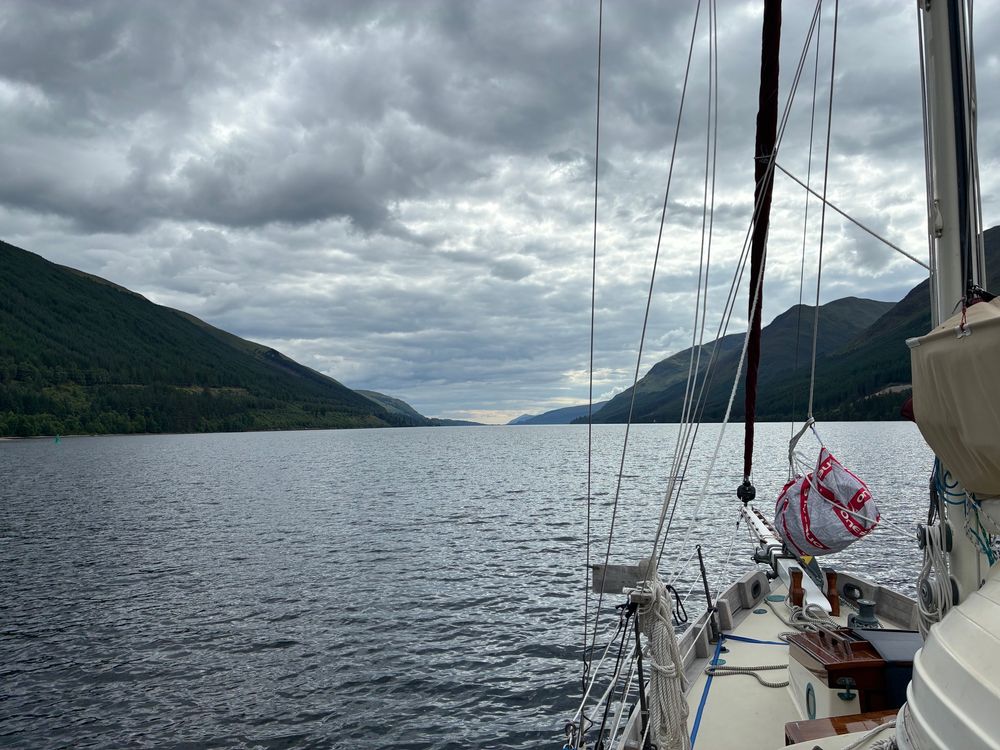 Loch Lochy, seen from the eastern end. It narrows to a point some 8 miles distant. The sky is cloudy but sublime.