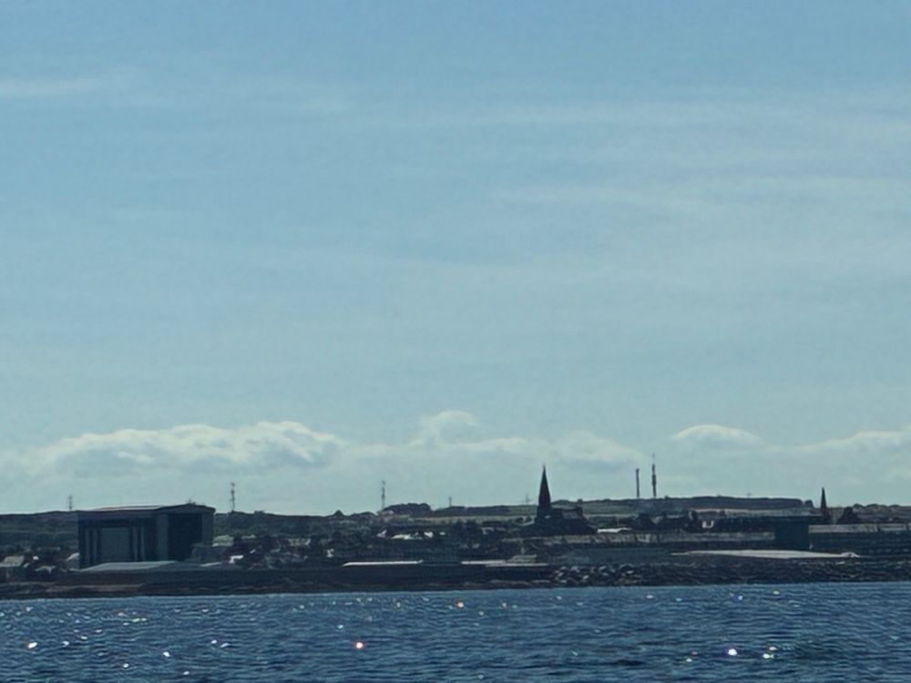 Peterhead seen about 1nm away off the port beam. Closest we see the working Port henry fish docks, with the Chruch of Scotland steeple marking the center of town.