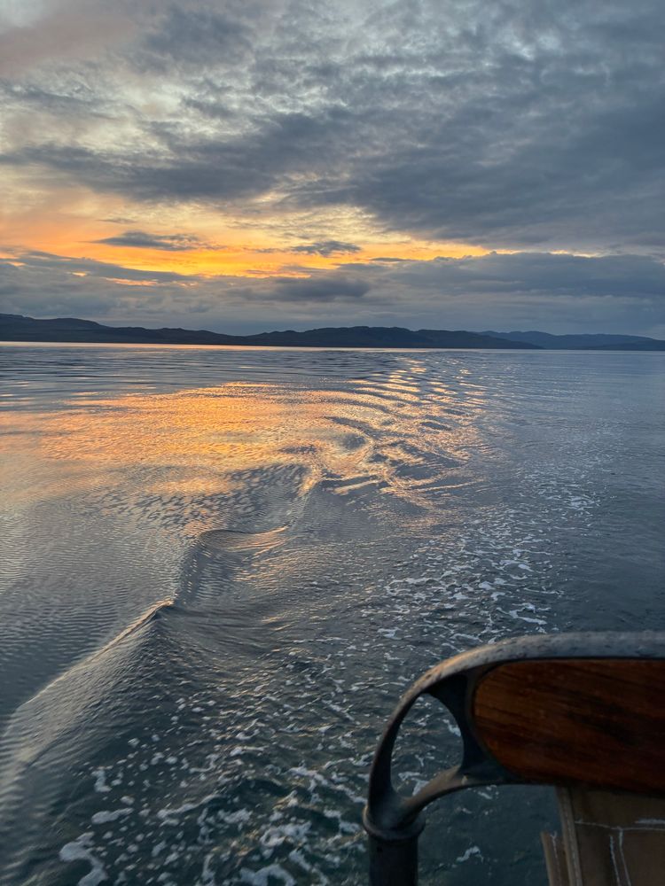 Motoring down the Sound of Jura as the sun sets behind me. A very orange sunset reflected in very calm water. The sea is only broken by Indigo’s polite wake. 