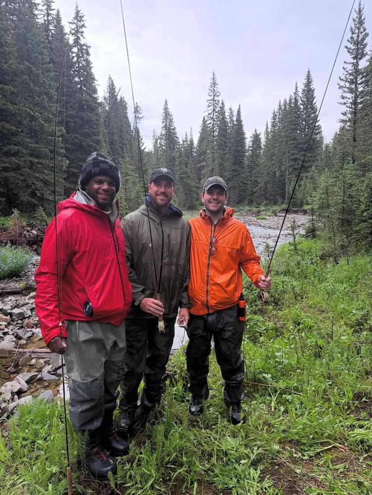 A photo of Travis Kelce, Austin Swift and a friend Travis didn’t tag for some god forsaken reason in fly fishing gear in the woods by a stream