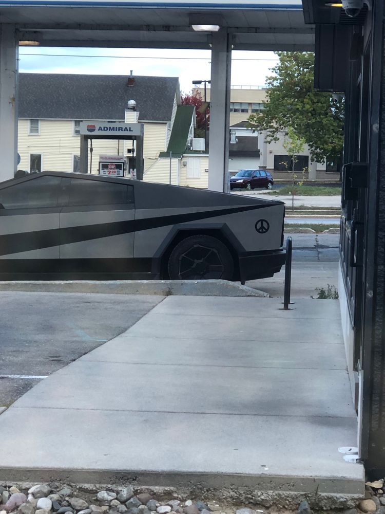 Close up on the peace sign on a cyber truck of all things.