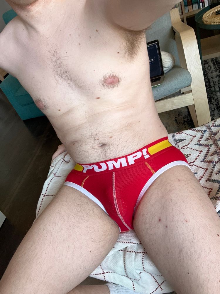 Photo of a pale guy wearing red and yellow PUMP! briefs