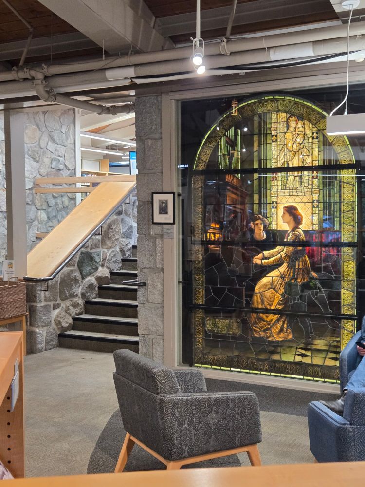 Stained glass style image next to a stone and wood stairwell