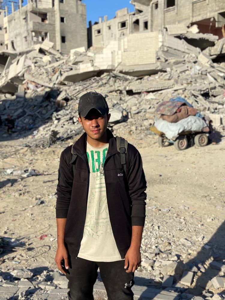 A photo of Mohammed, 19yo.
He is standing in front of destruction.
The Photo is taken while displacement and famine in genocide. Gaza, Palestinr.