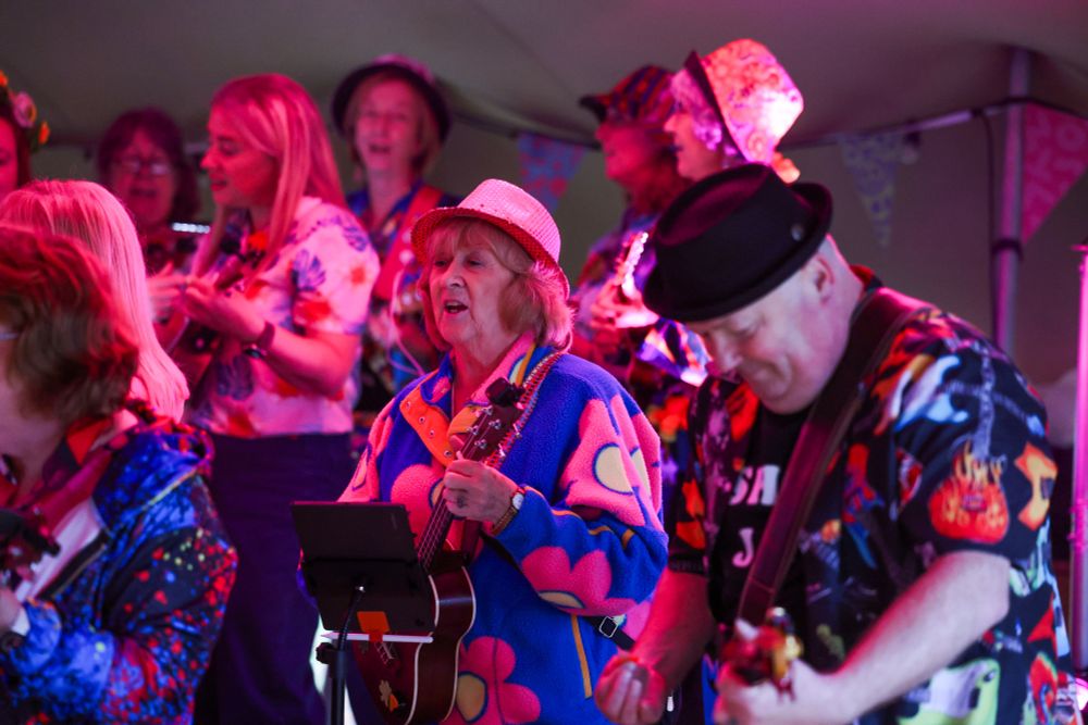 a ukelele band in colorful hawaiian shirts
