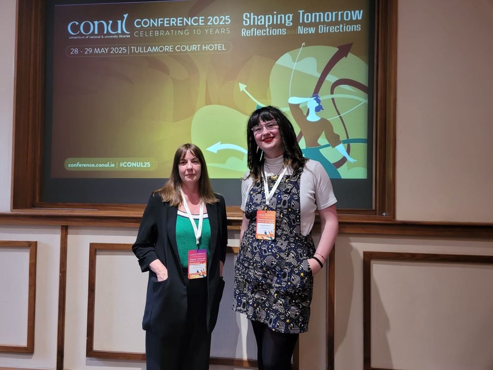 Two women standing in front of a presentation screen with the following text: Conul conference shaping tomorrow 