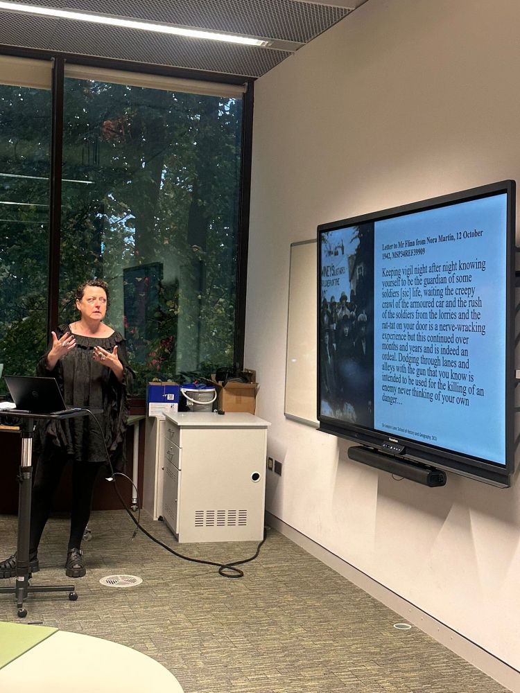 Dr. Leeann Lane giving a lecture in front of a screen