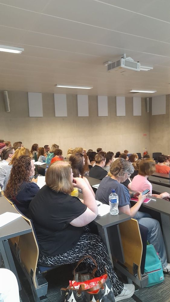 Rows of people seated in a lecture theatre
