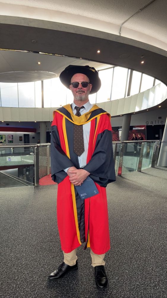 A man wearing sunglasses and ceremonial robes