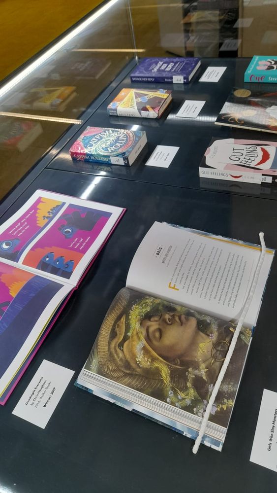 Books laid out in a glass exhibition case