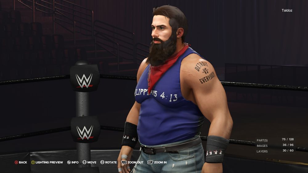 Front left view of Create a Wrestler screen. Male wrestler wears a blue tanktop that says "Philippians 4:13", distressed blue jeans, work boots, red banana that says "SOLIDARITY", and black wrist wraps that say "Hope" and "Prey". He has a long brown beard, green eyes, medium brown hair, and white skin. He has a black, bolded letters tattoo on his left shoulder that says "Detroit vs Everyone"