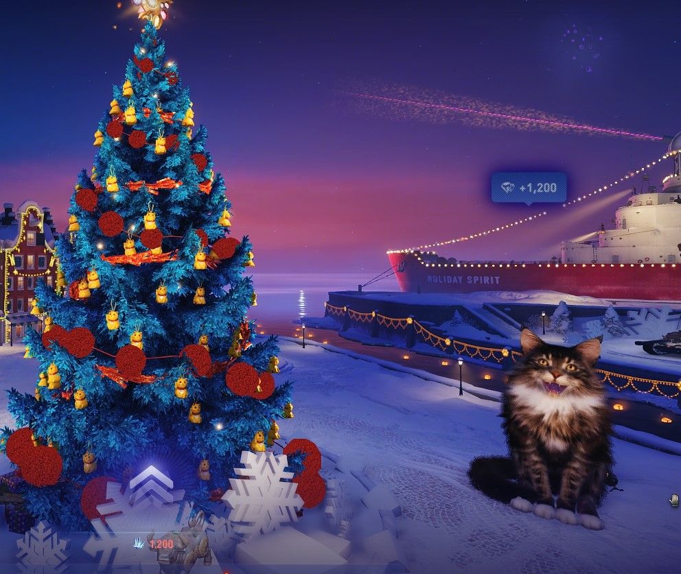A World of Tanks holidays garage covered in snow and ice. There is a blue Christmas tree with a red ball garland and gold cat ornaments. A ship with string lights is in the background. A giant, fluffy Redshire Cat sits between the two, mouth open in a meow.