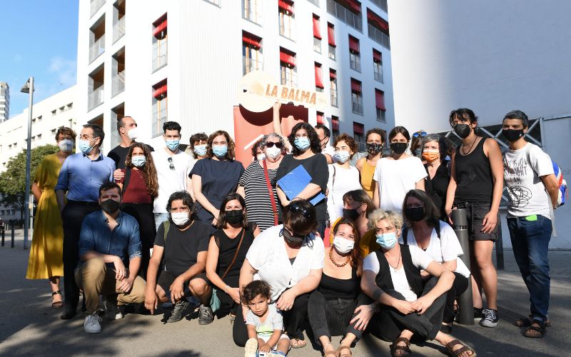 picture of residents Infront of their apartment block, 