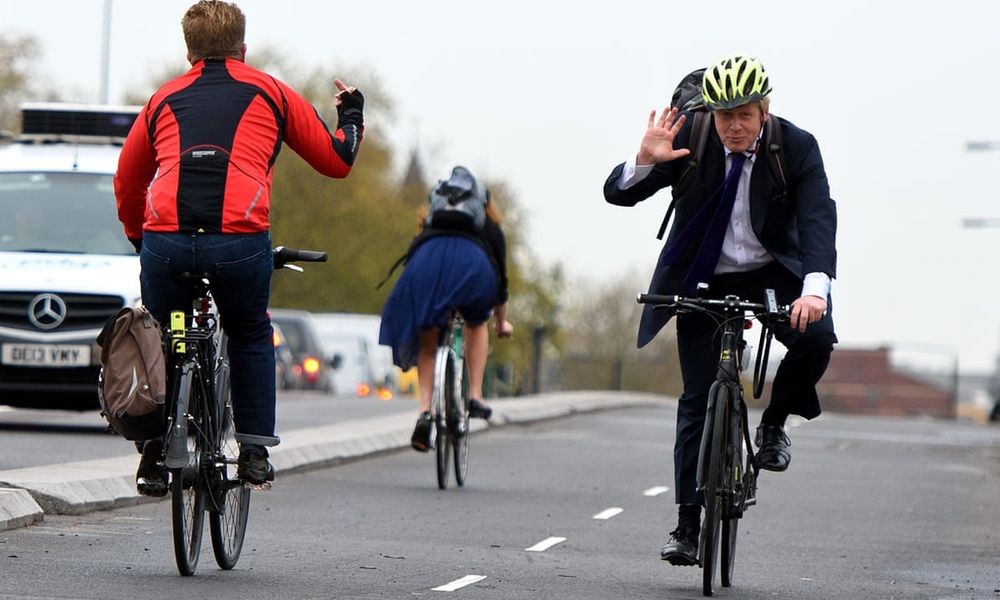 Passing cyclist giving Boris Johnson the bird.