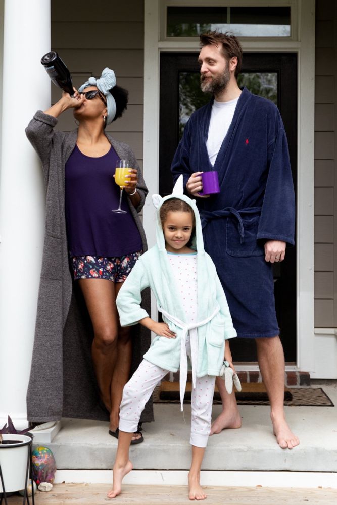 A silly photo of Kelli, Andy, and The Biscuit in pajamas on their porch during the Covid lockdown in 2020. 
