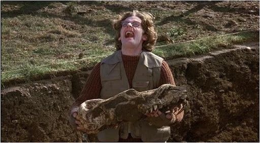 An image of Peter Capaldi holding a skull and screaming towards the sky