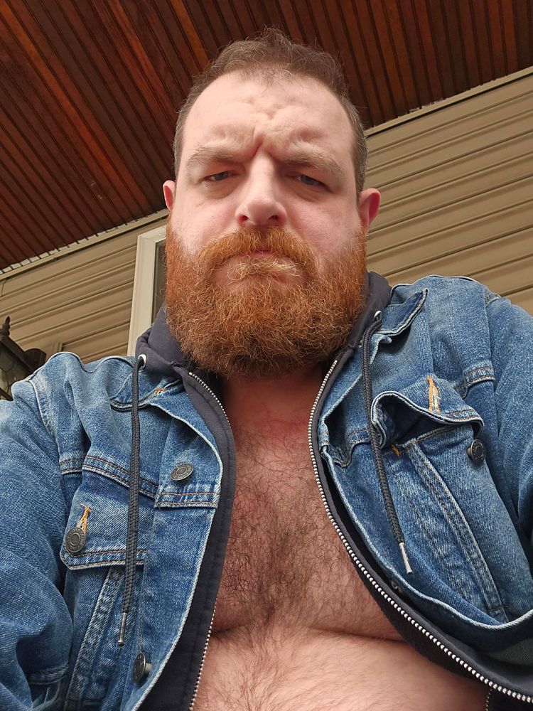 Incredibly handsome gay bear making a very scary face. Also, he's super hot 😂