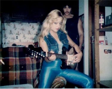 RAW POWER embodied in a blonde playing an electric guitar. 