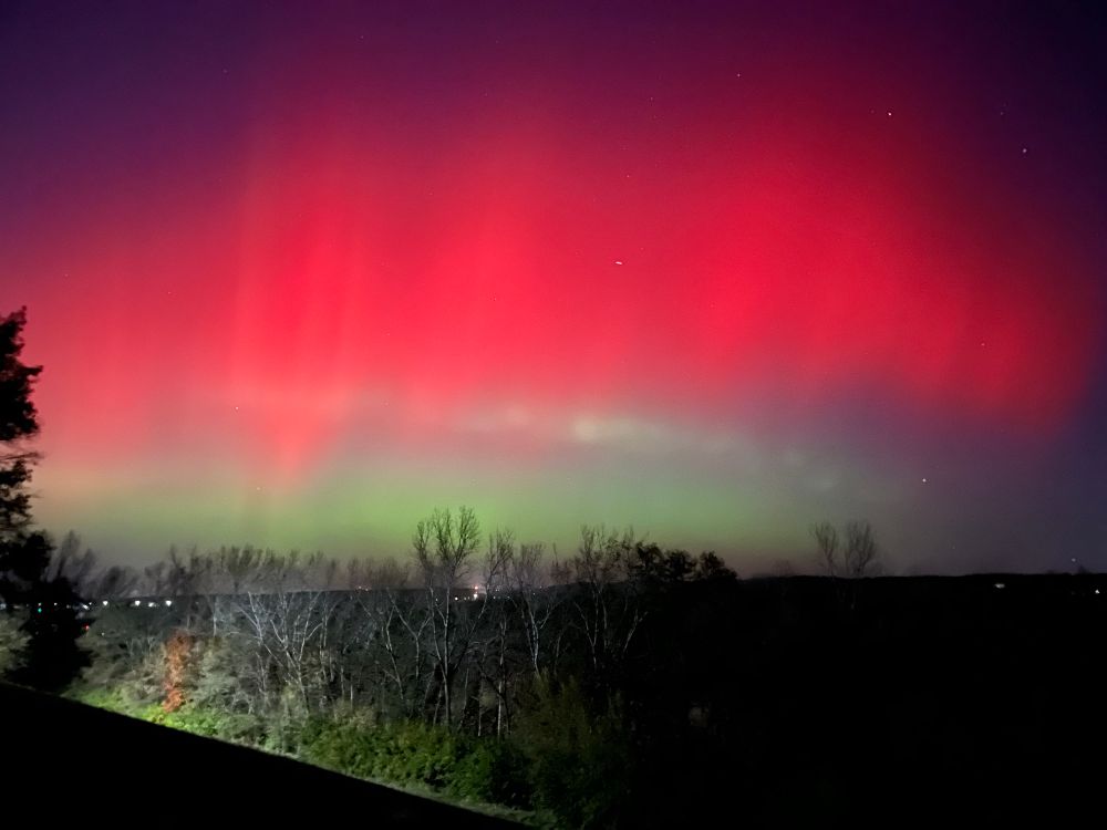 The night sky with bright green fading into red