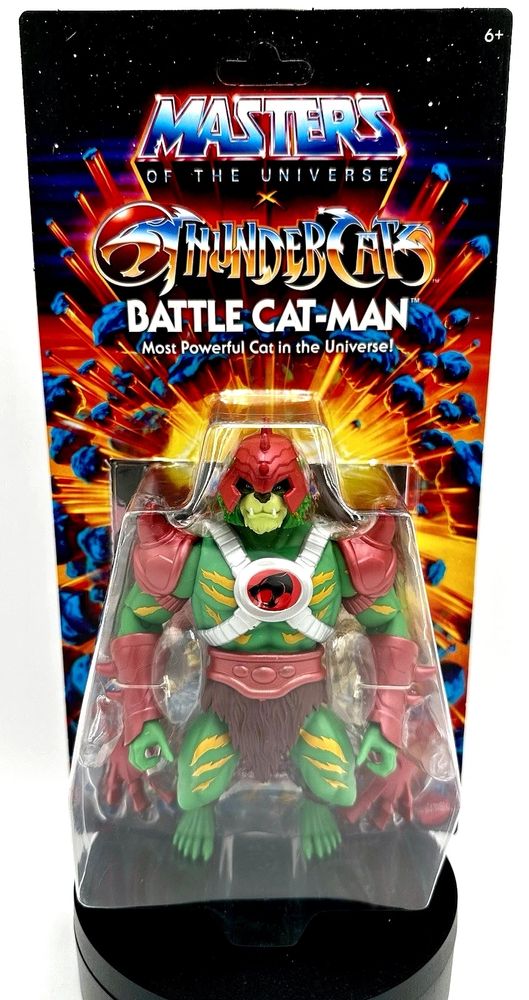 A blister carded action figure from the Masters of the Universe/Thundercats crossover that has a green and orange stripped tiger headed humanoid in red armor, named Battle Cat-Man.