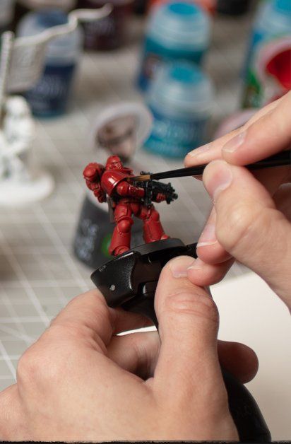 Someone painting a Warhammer Space Marine