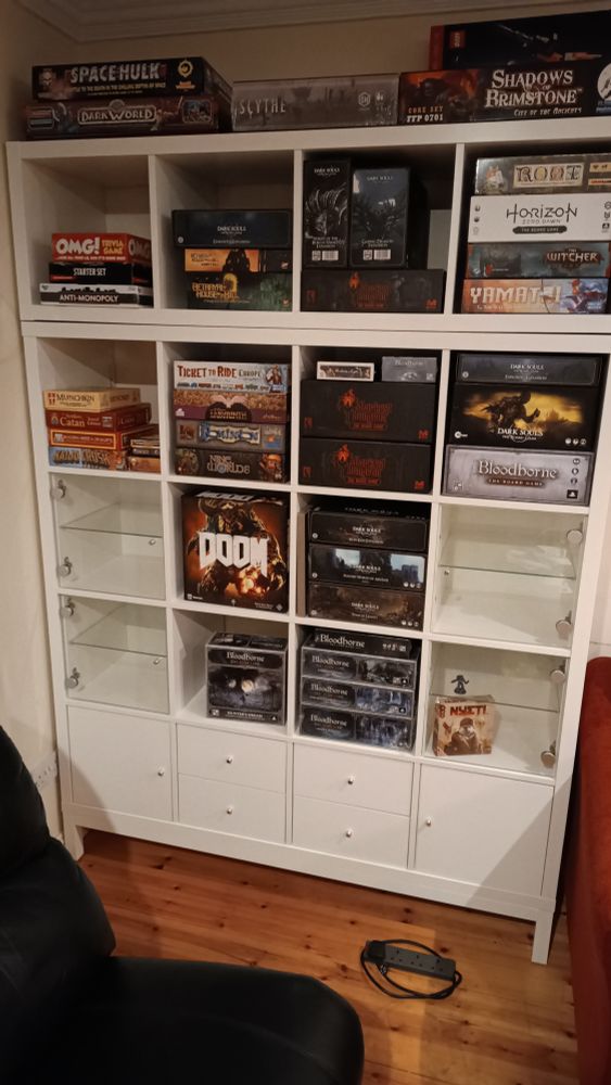 New IKEA Kallax shelves with various boardgames and expansions including Dark Souls, Bloodborne, Darkest Dungeon, Root, Scythe, Ticket to Ride and more