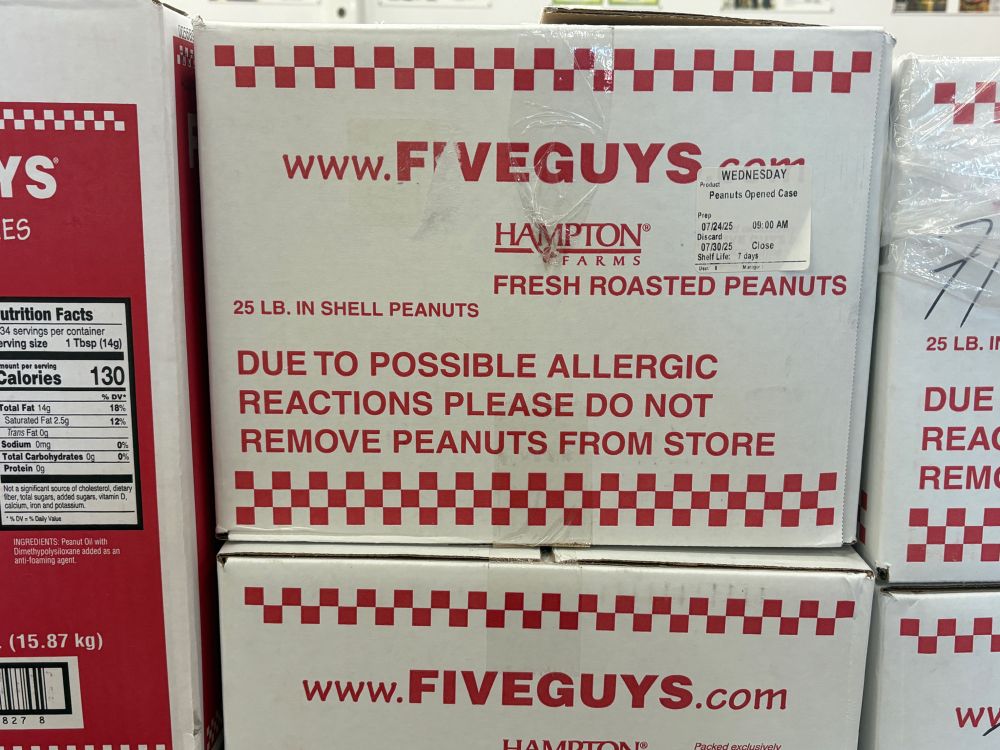 Box of peanuts with warning “due to possible allergic reactions please do not remove peanuts from store” 