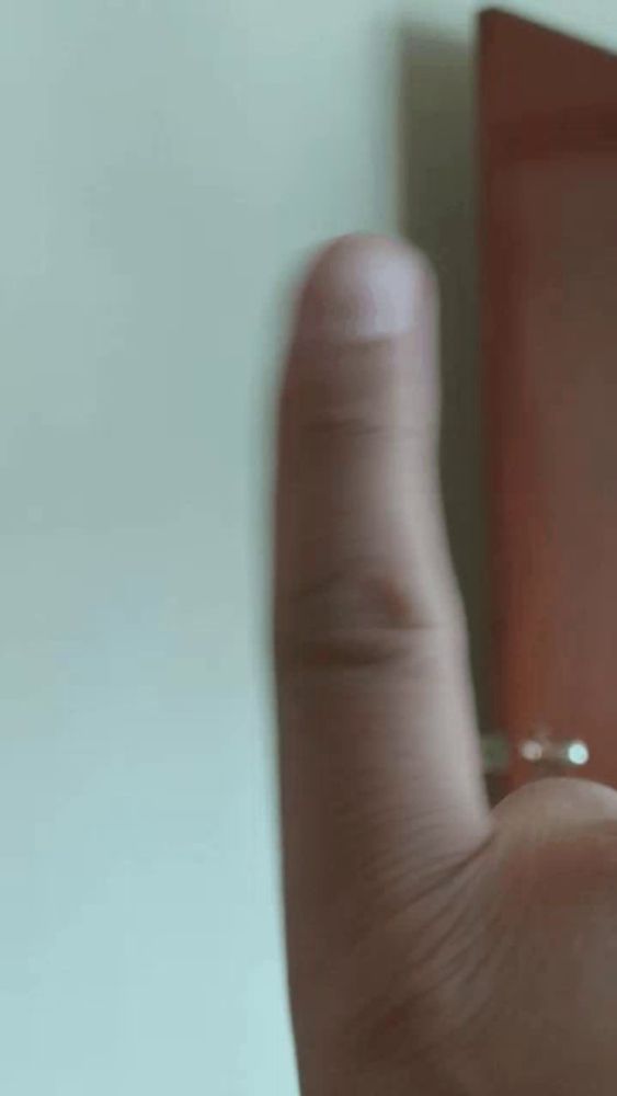 a close up of a person 's thumb with a ring on it