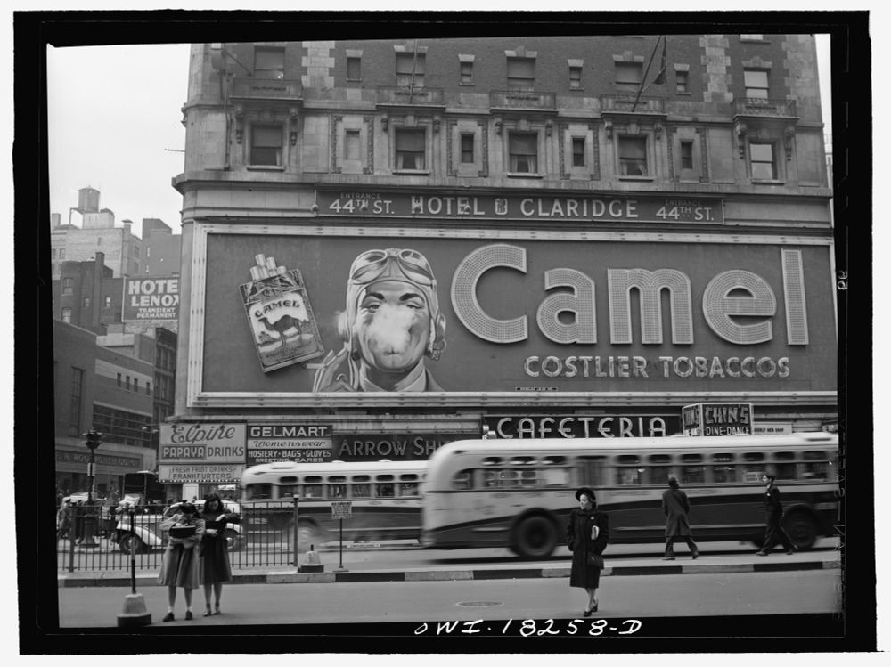 Public domain: sepia photograph showing a billboard, advertising Camela Costlier Tobaccos. 