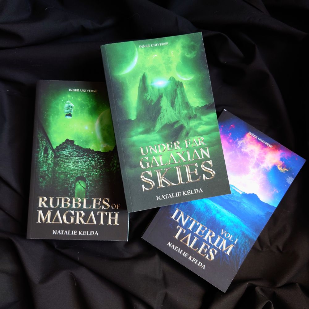 3 paperback books on a black backdrop. One is lying on top of the other two and is titled Under Far Galaxian Skies and has a green cover with a mountain. To the left below is Rubbles of Magrath which also has a green cover but city ruins and a flying wooden ship in the background. The book to the right is titled Interim Tales Vol 1 and has a blue and violet scenery 