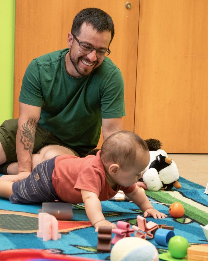 A father and baby playing at the Library
