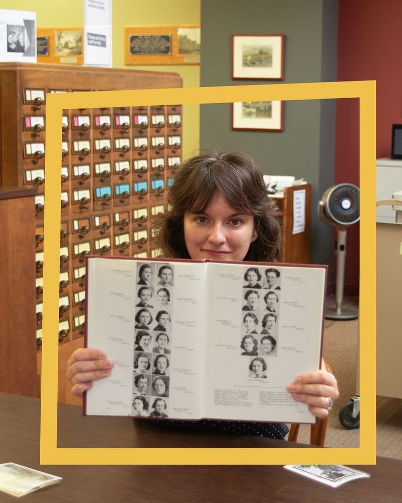 Sammy Orlowski holds up an old yearbook open to the page featuring her grandmother.