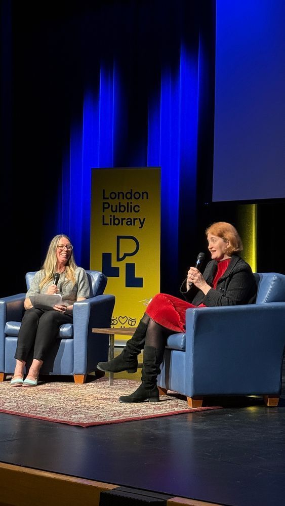 A moderator sitting next to author Emma Donoghue, both holding a mic. 