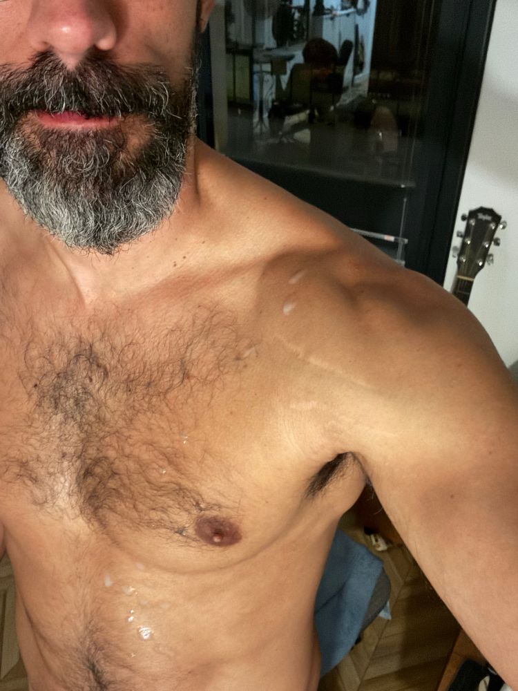 Scruffy man with drops of himself on his shoulder