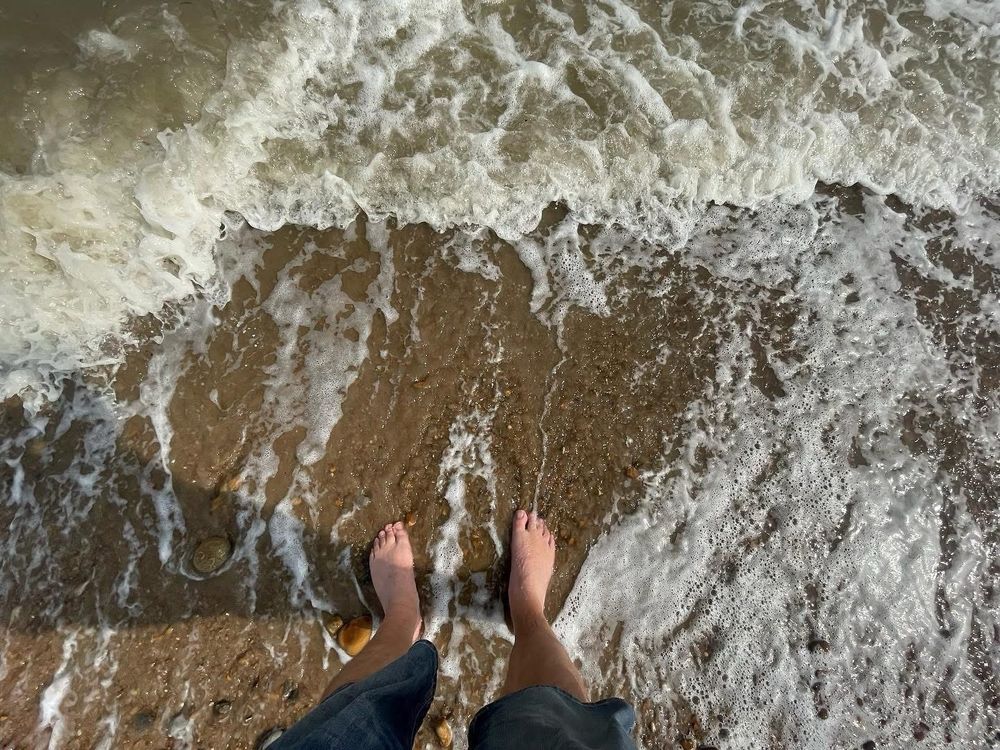 Two feet in the surf on the shoreline