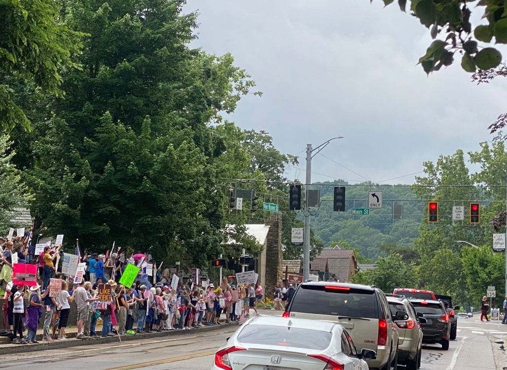 Intersection in Nashville, Indiana, with #NoKings protesters holding signs