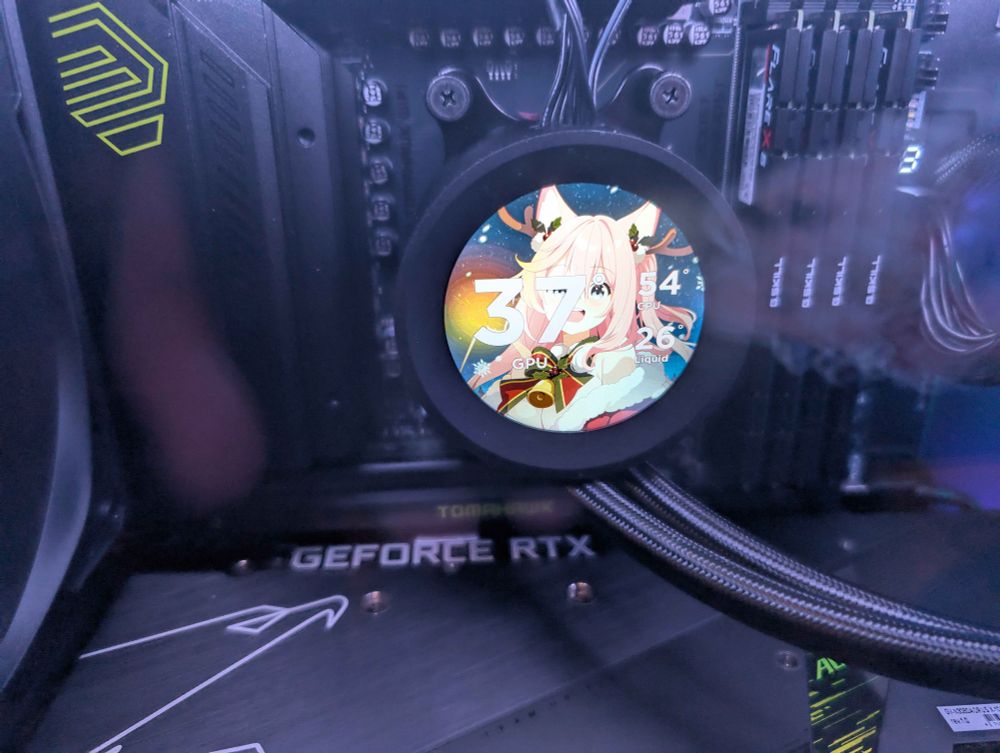 A picture of Hachi, a dog VTuber with pink hair, wearing a cute chrismasy outfit with antlers. The image is placed in a CPU cooler that show the temperatures of the GPU, CPU, and the liquid.