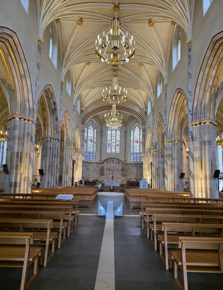 Center aisle view towards the altar of St Andrew’s RC Church in Glasgow, Scotland.