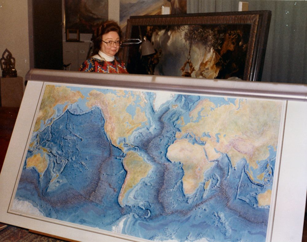 Marie Tharp with the iconic Heezen-Tharp World Ocean Floor map, a landmark in cartography. Credit: Lamont-Doherty Earth Observatory and the estate of Marie Tharp