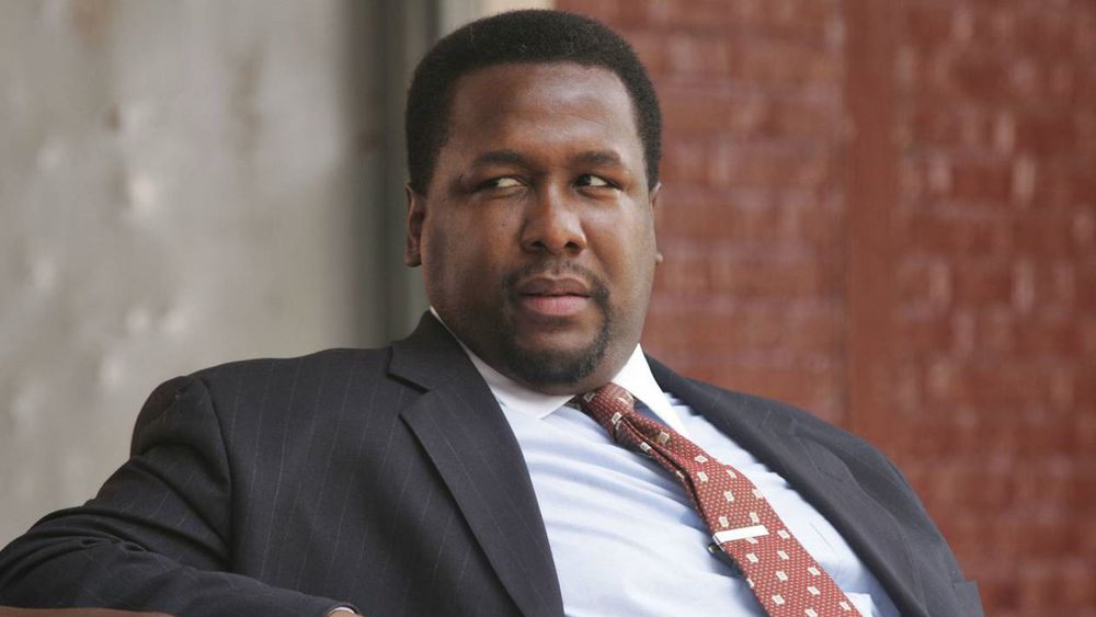 Wendell pierce as Bunk Moreland. Black man in suit and tie giving someone the side eye 