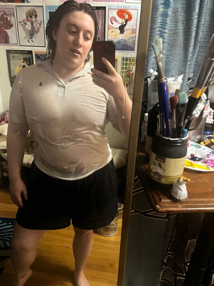 Me covered in rain with my clothes and hair drenched posing in the mirror 